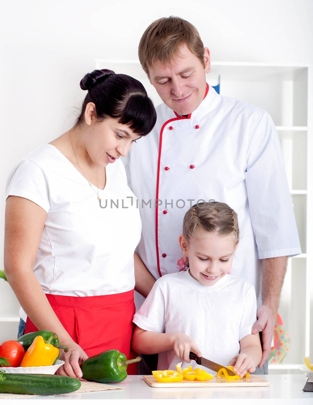 portrait happy family is cooking dinner together