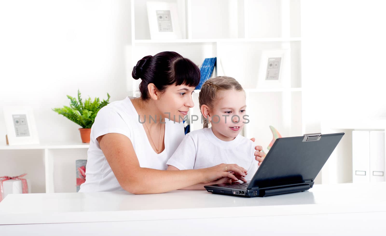 Mom and daughter are working together for a laptop by adam121