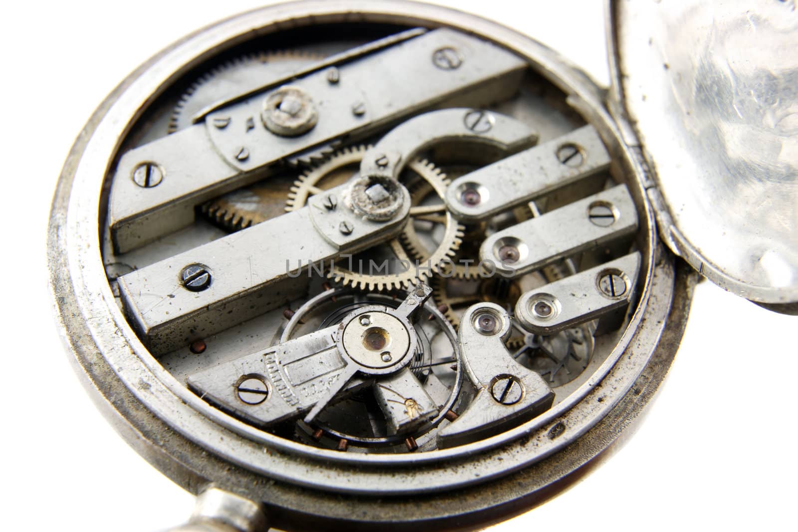 old silver pocket watch mechanism on white background