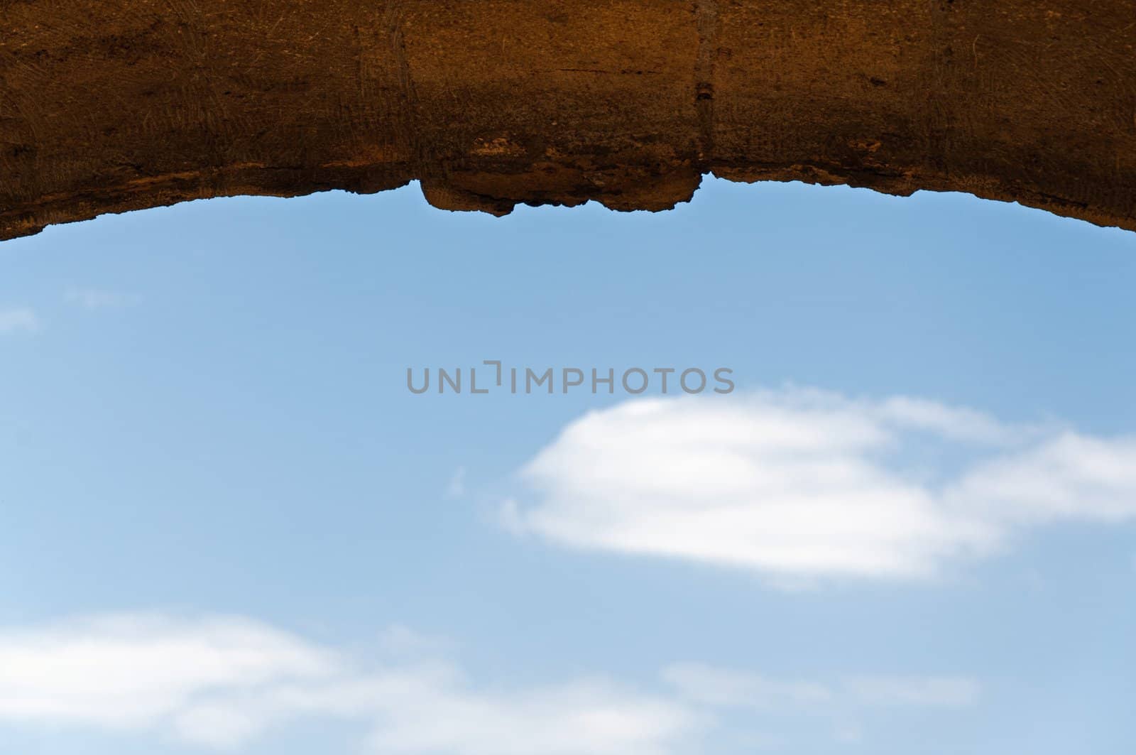 Background - an old stone arch on a background of the blue sky.