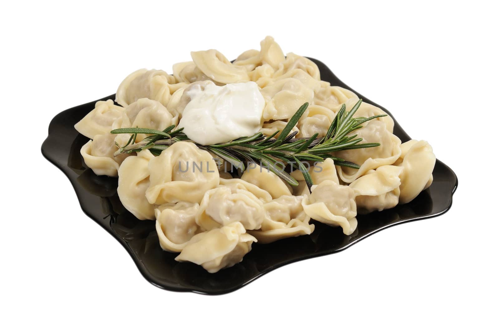 Ready to eat ravioli on a plate. Decorated with rosemary. Isolated on white.