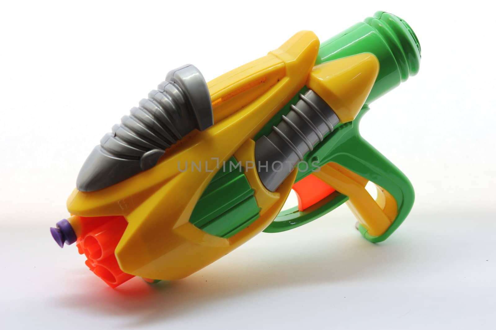 Yellow and green dart gun loaded with one purple dart.