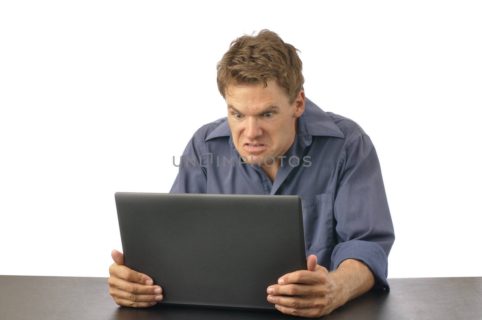 Angry man strangles laptop computer on white background