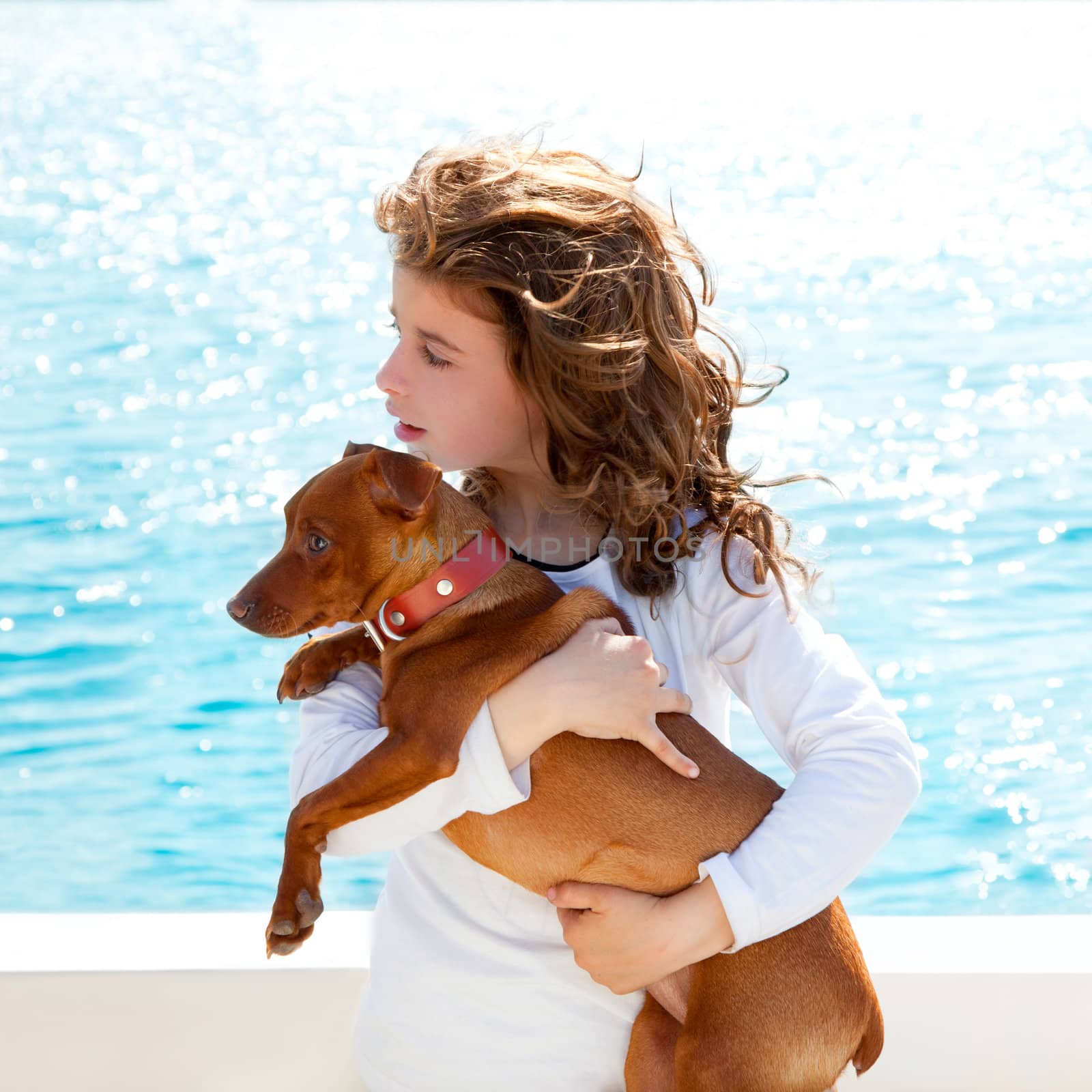 brunette kid girl with dog on the sea view from a boat