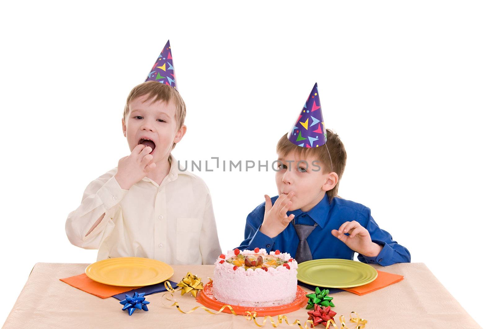 two boys eating a cake his hands isolated on white background