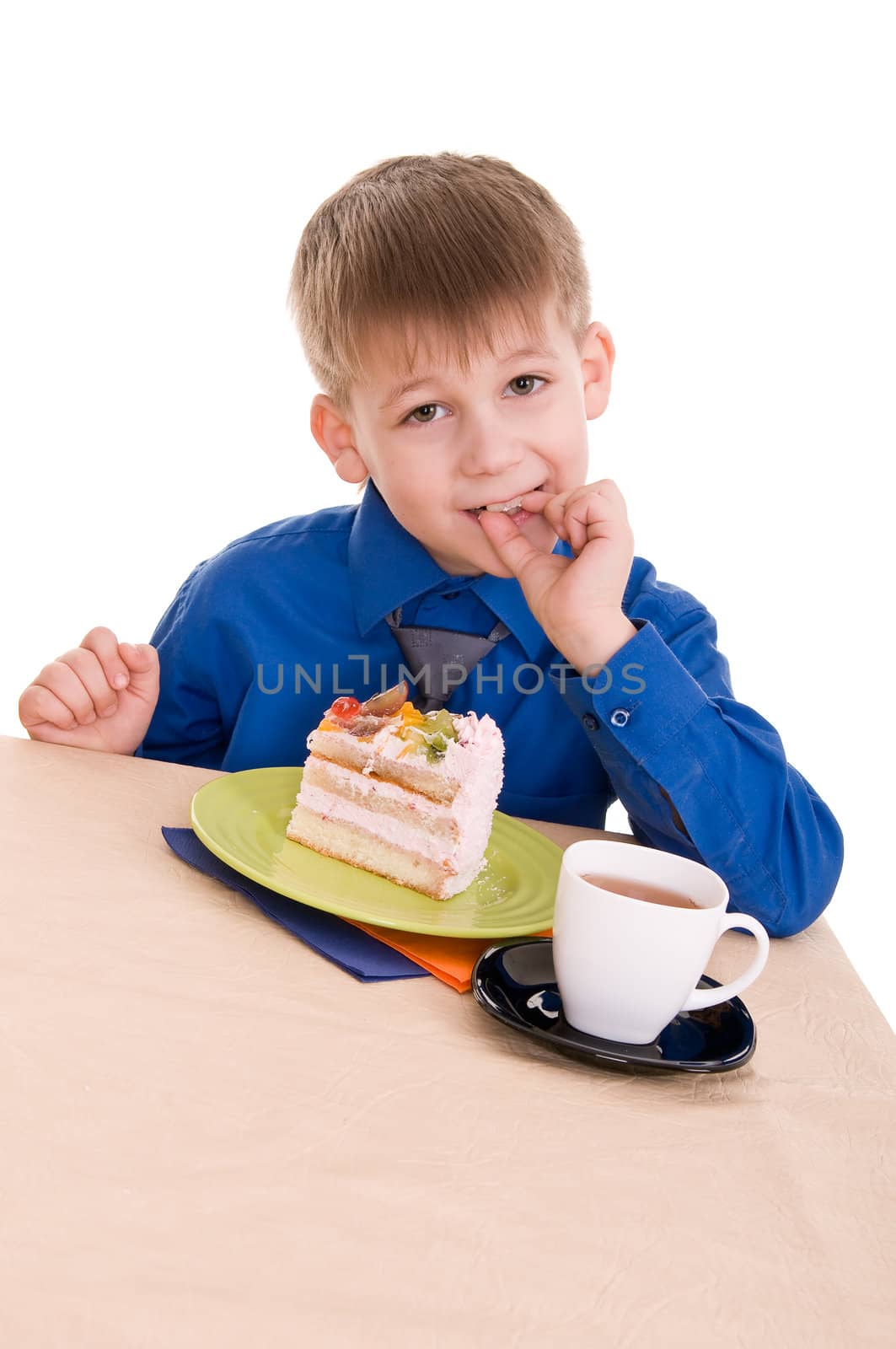 portrait of a child who eats the cake isolated on white background