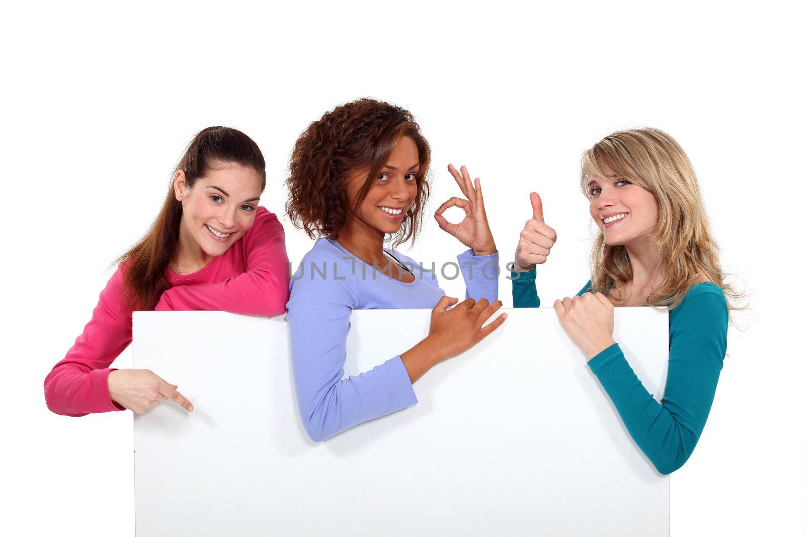 Women enthusiastically holding up a blank sign