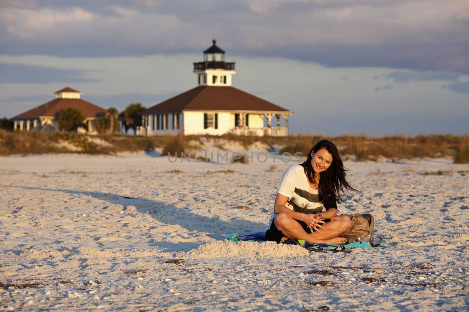Girl enjoying the beach with Boca Grande Lighthosue 