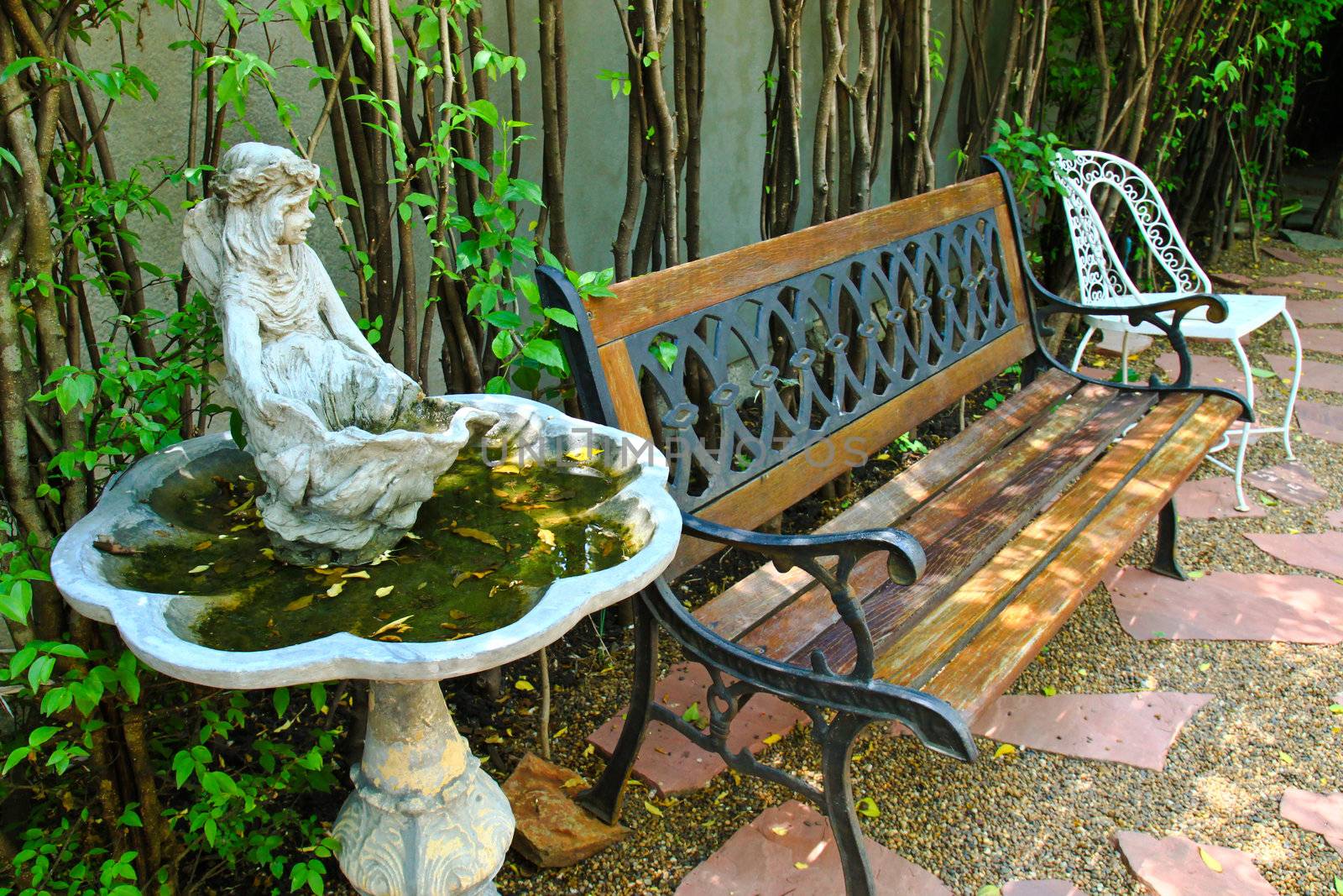 Bench and old fountain in garden by nuchylee