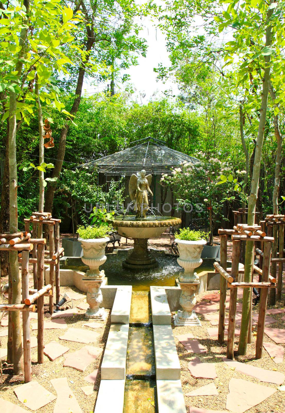 Angel sculpture fountain in the garden by nuchylee