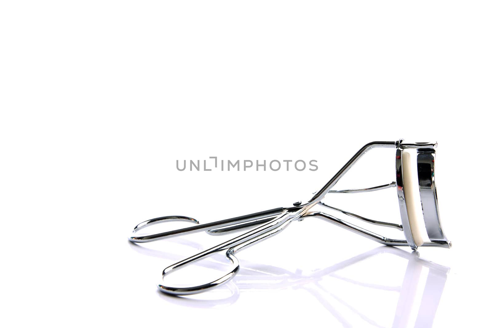 Eyelash curler on the white background with copy space