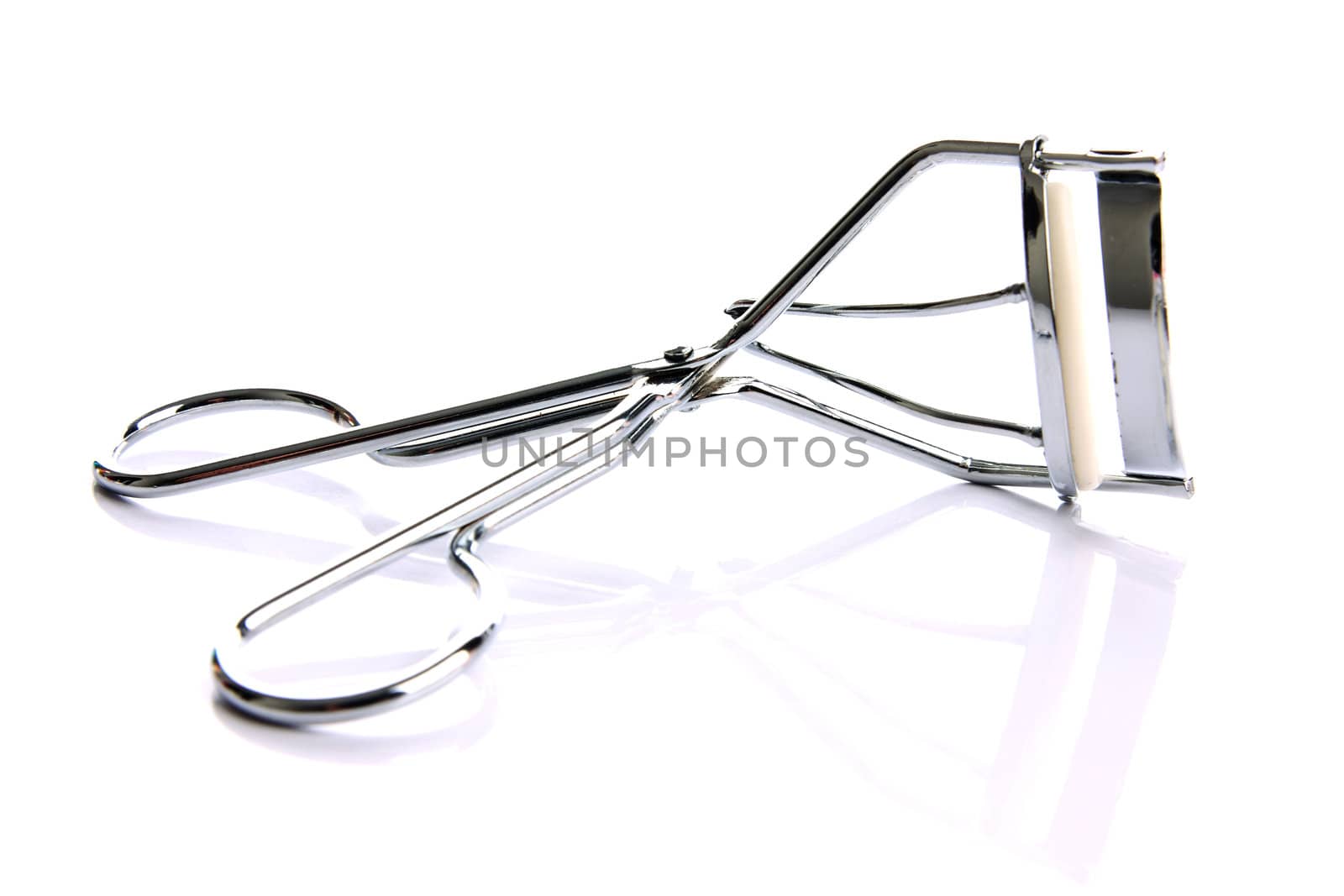 Eyelash curler on the white background