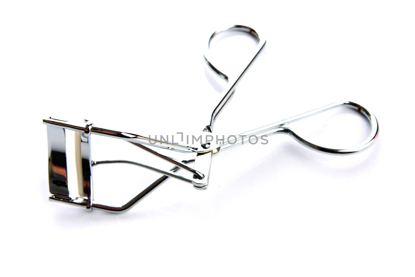 Eyelash curler on the white background