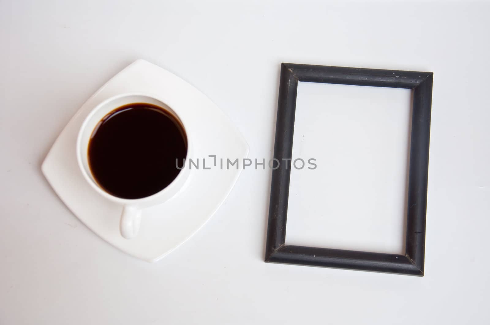 Black coffee and blank frame on white background