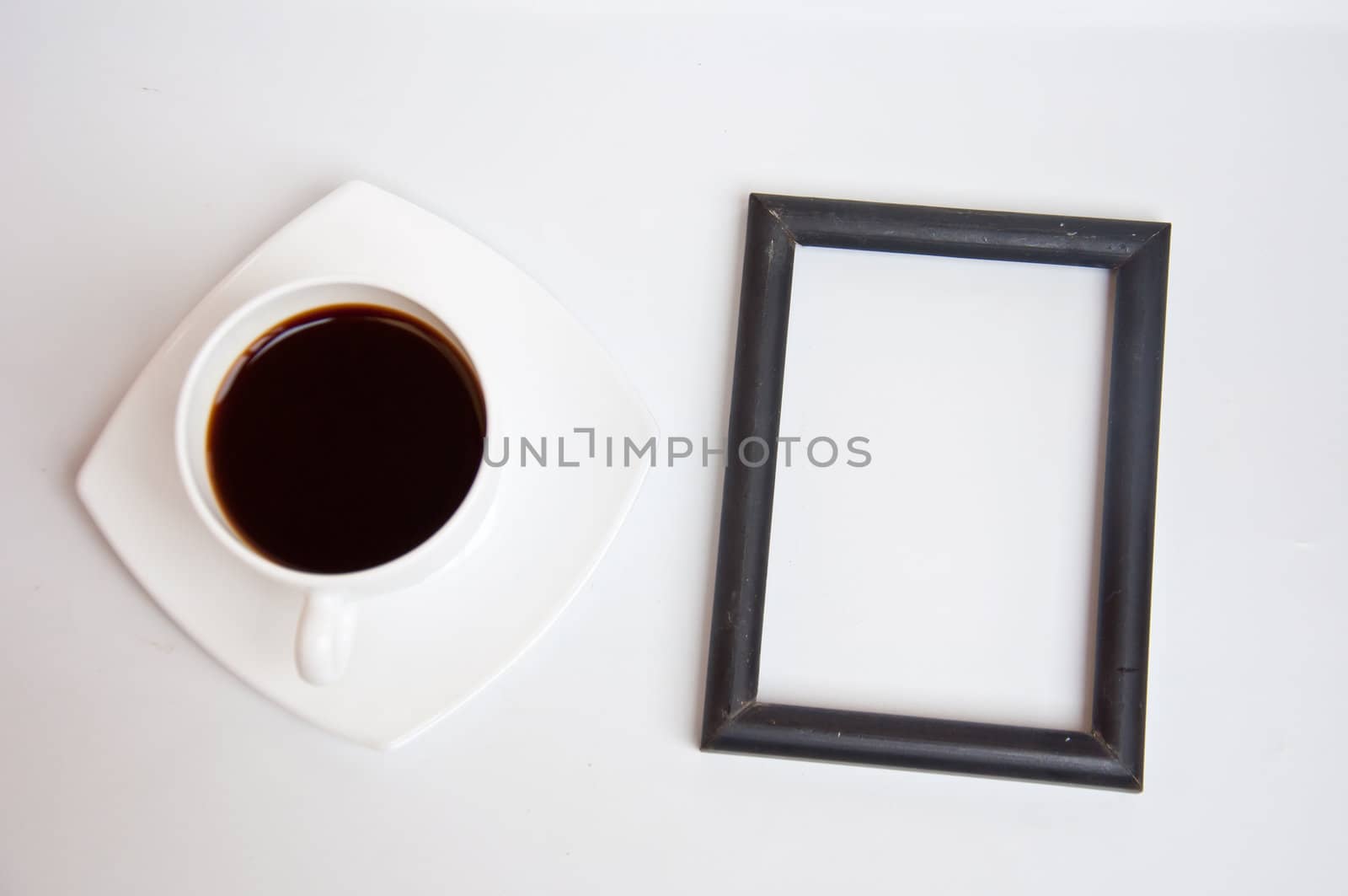 black coffee and blank frame on white background