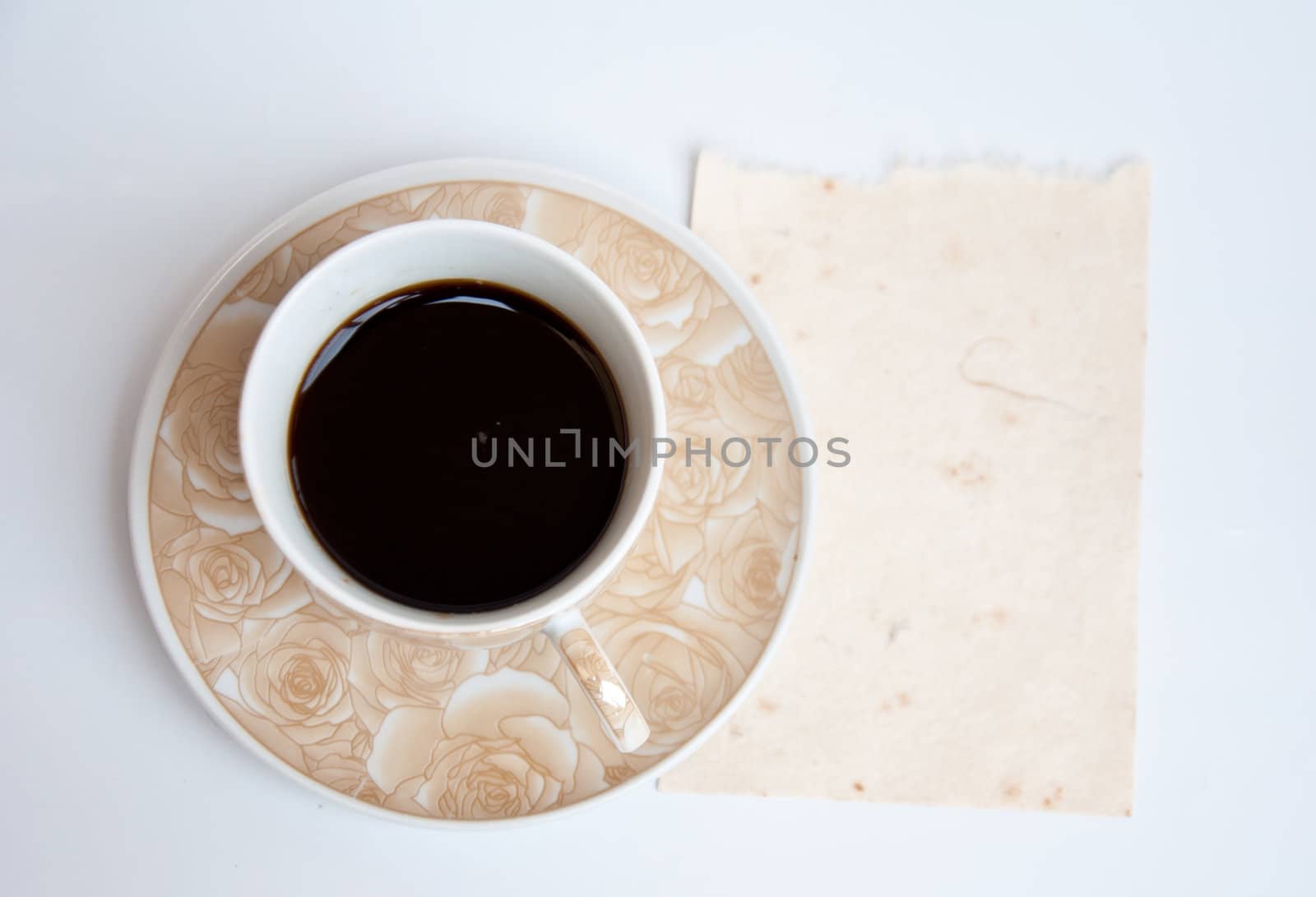 Blank paper and black coffee on white background