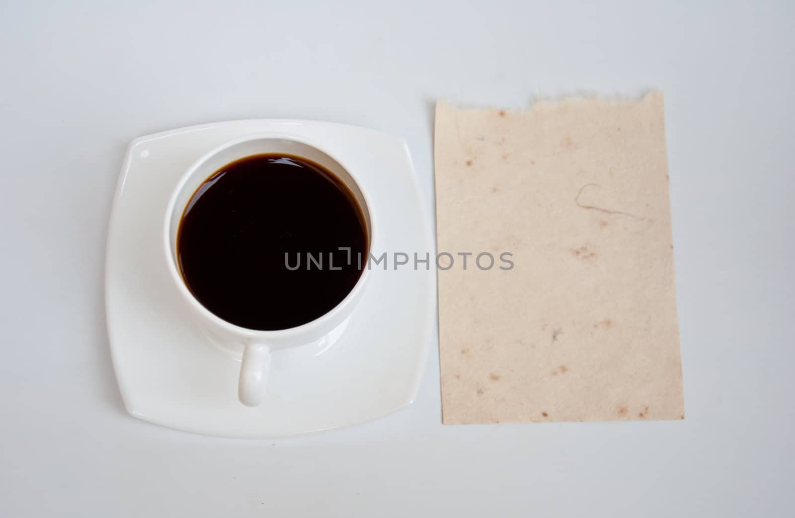 Blank paper and black coffee on white background