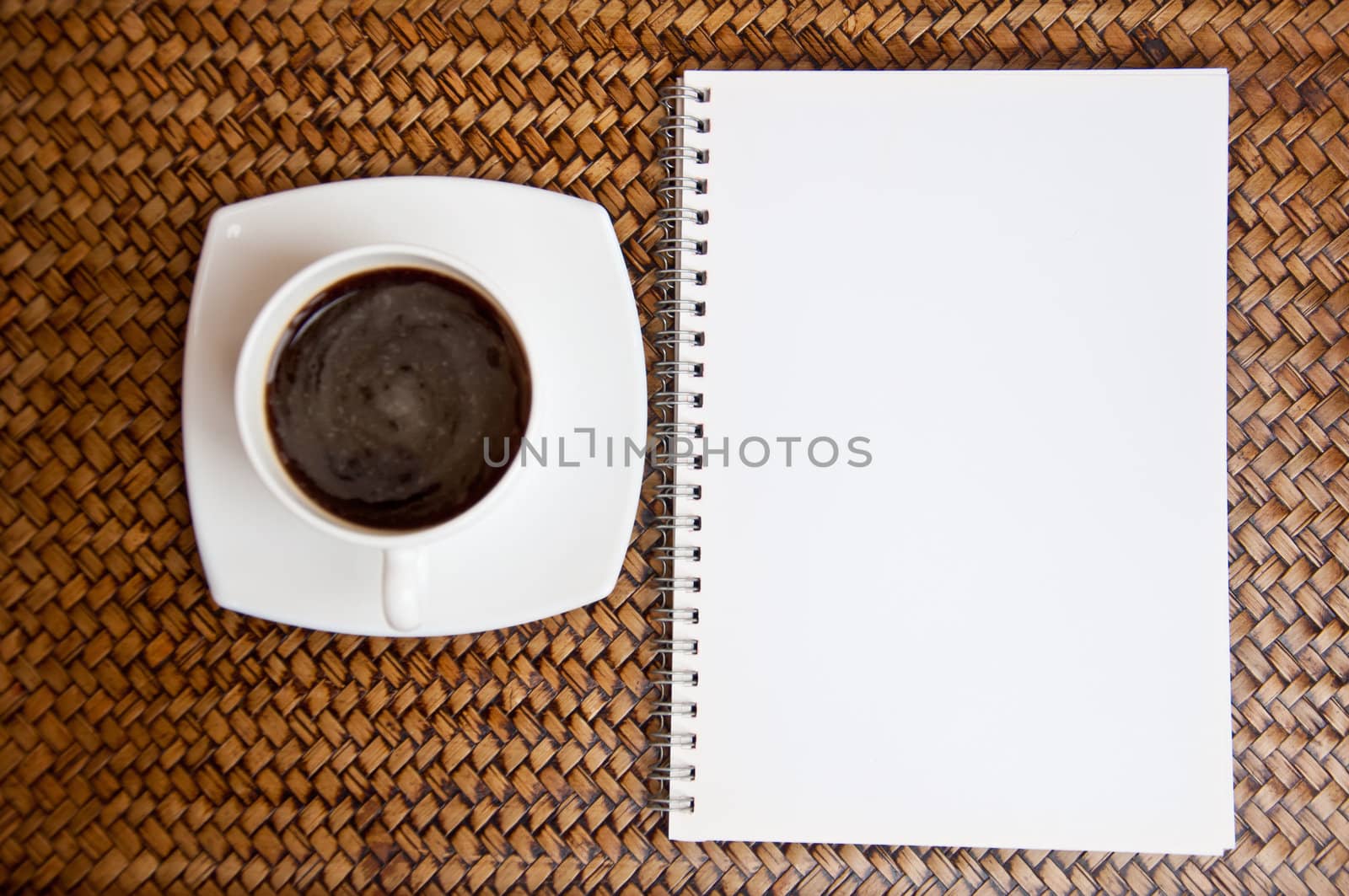 blank paper and black coffee on wood background