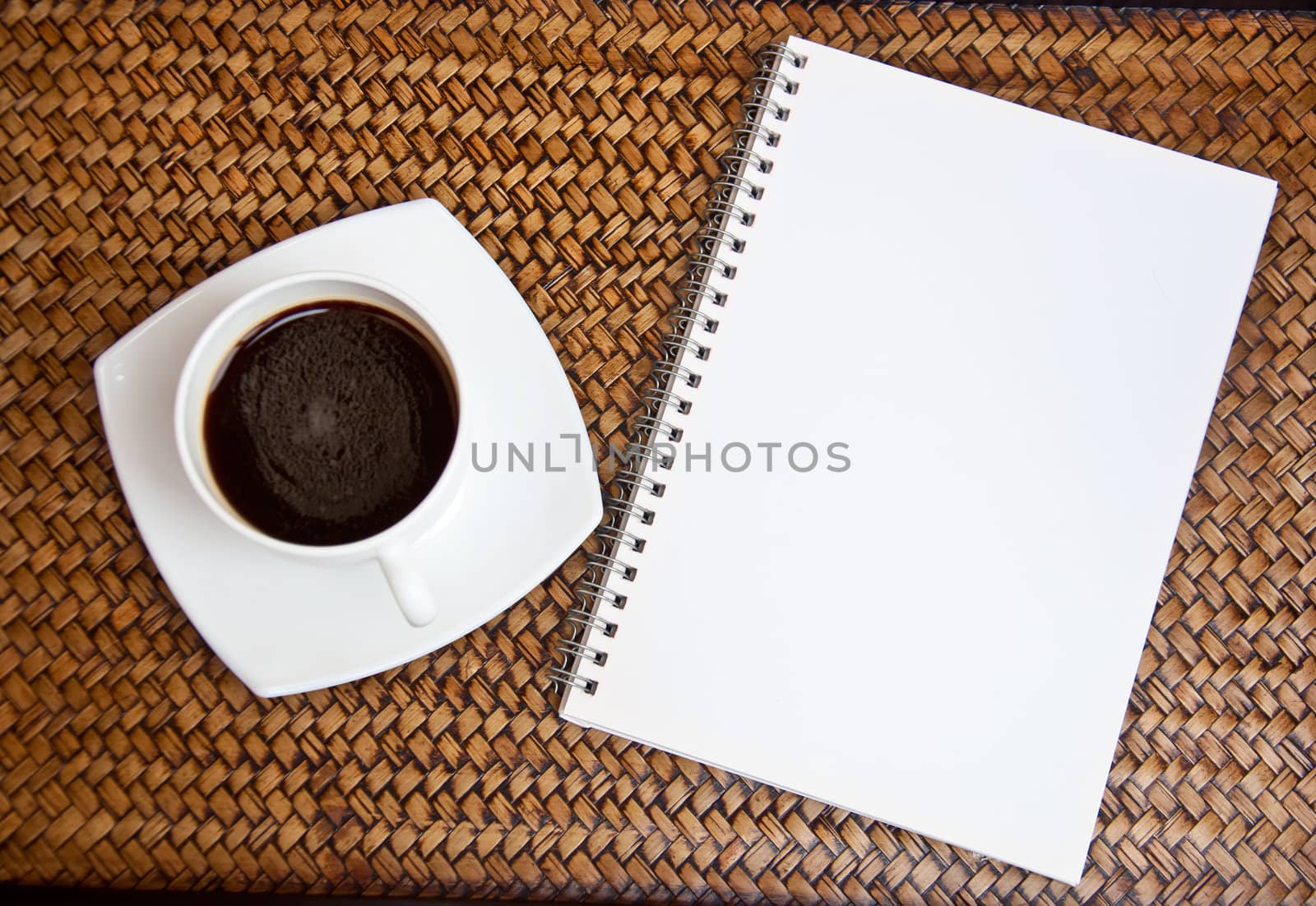 blank paper and black coffee on sedge background