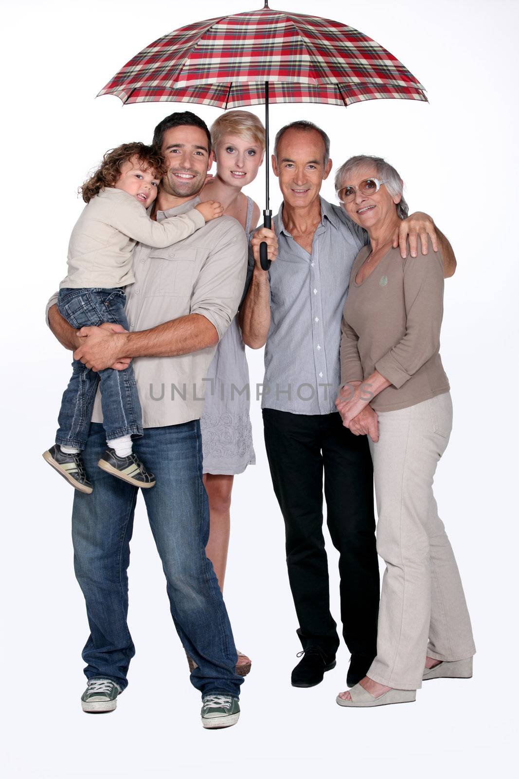 Family standing under umbrella