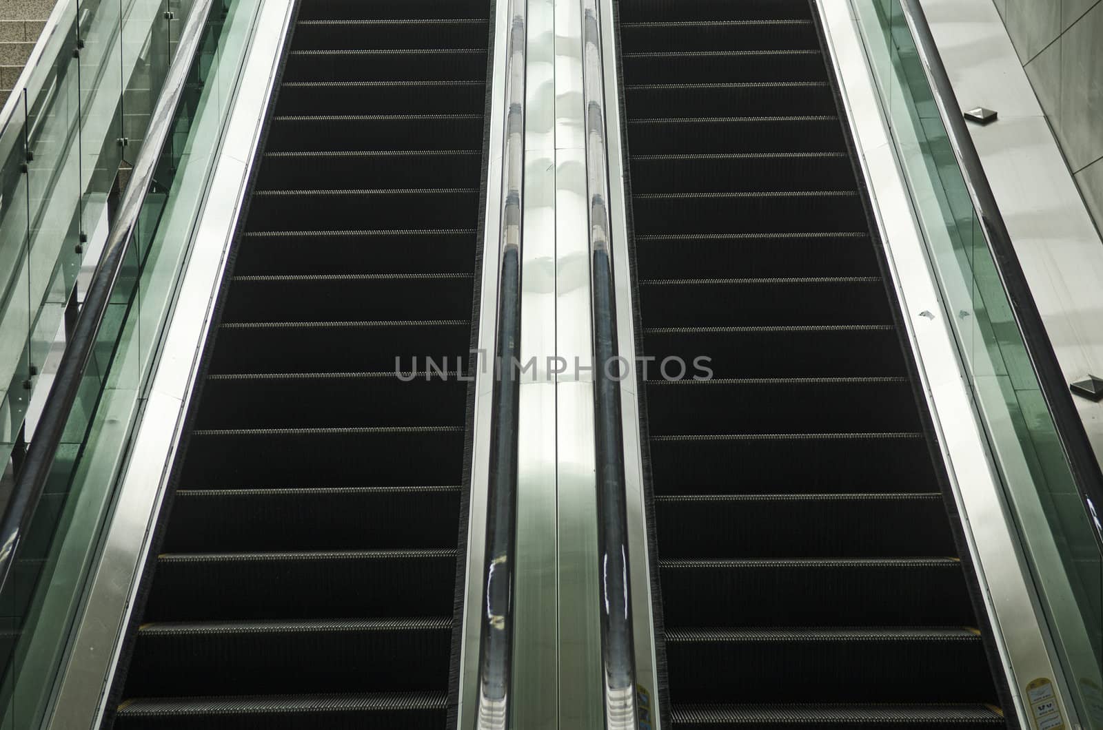 modern glass and metal escalator detail by jackmalipan