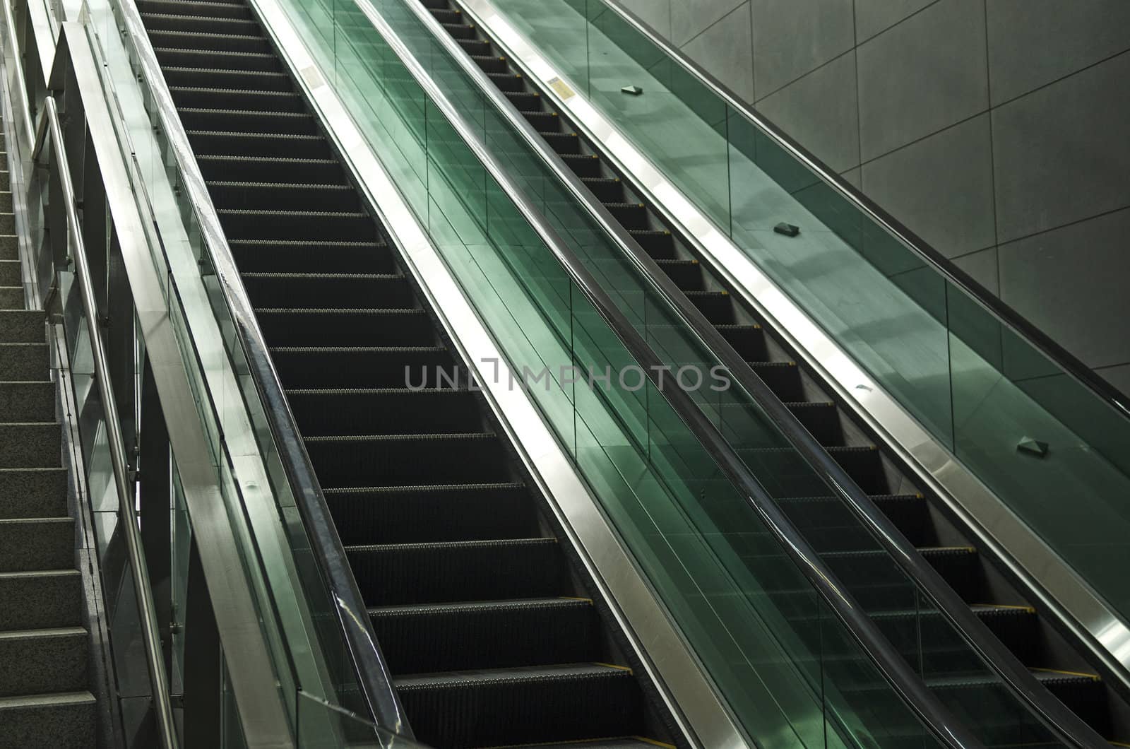 detail of modern glass and metal escalator by jackmalipan