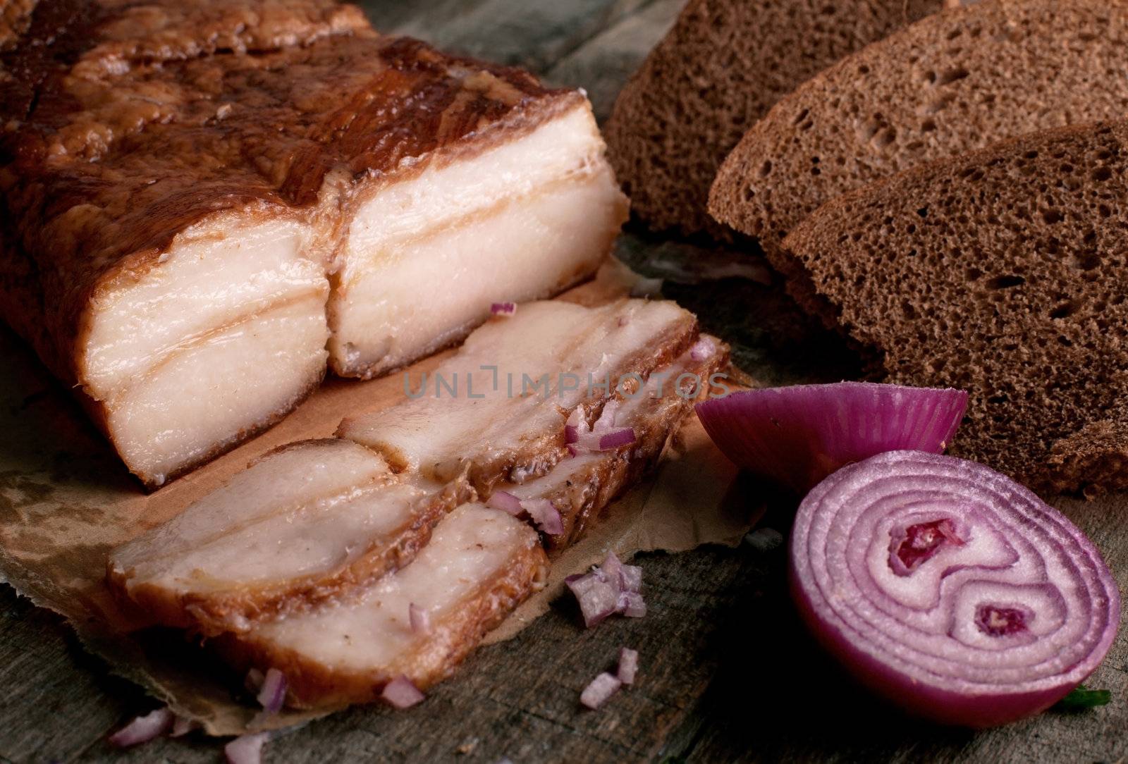 Fresh fat with onion and breаd on a wooden table