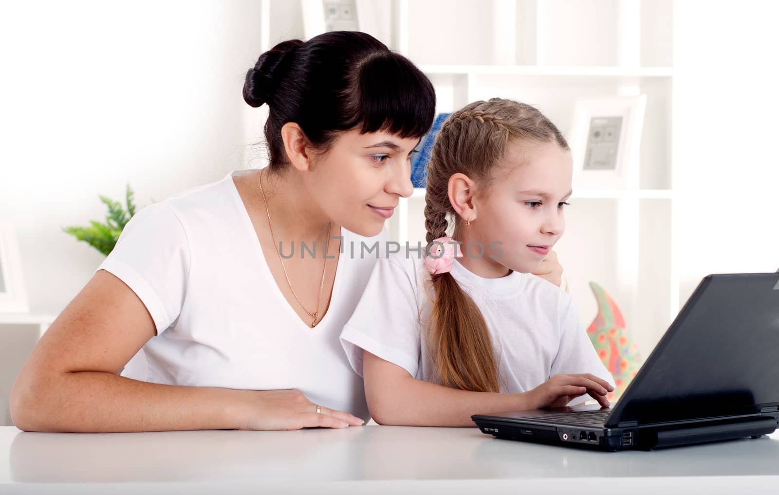 Mom and daughter are working together for a laptop by adam121