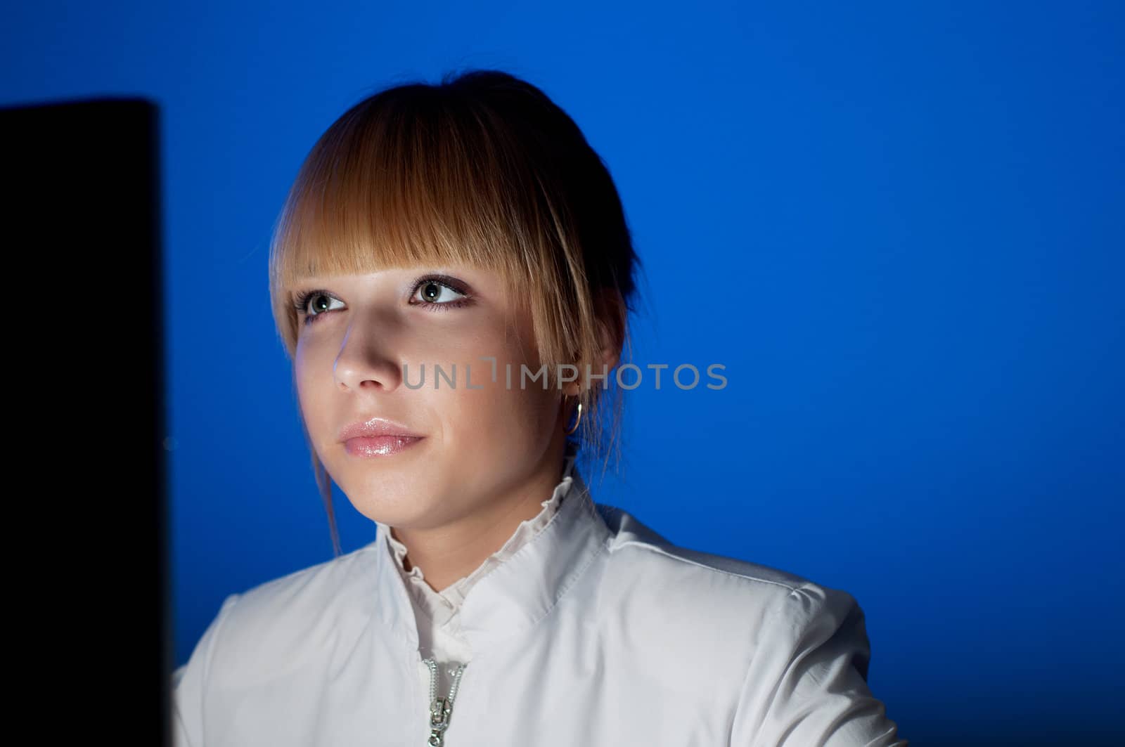 beautiful young woman doctor working at night in the office, smiling