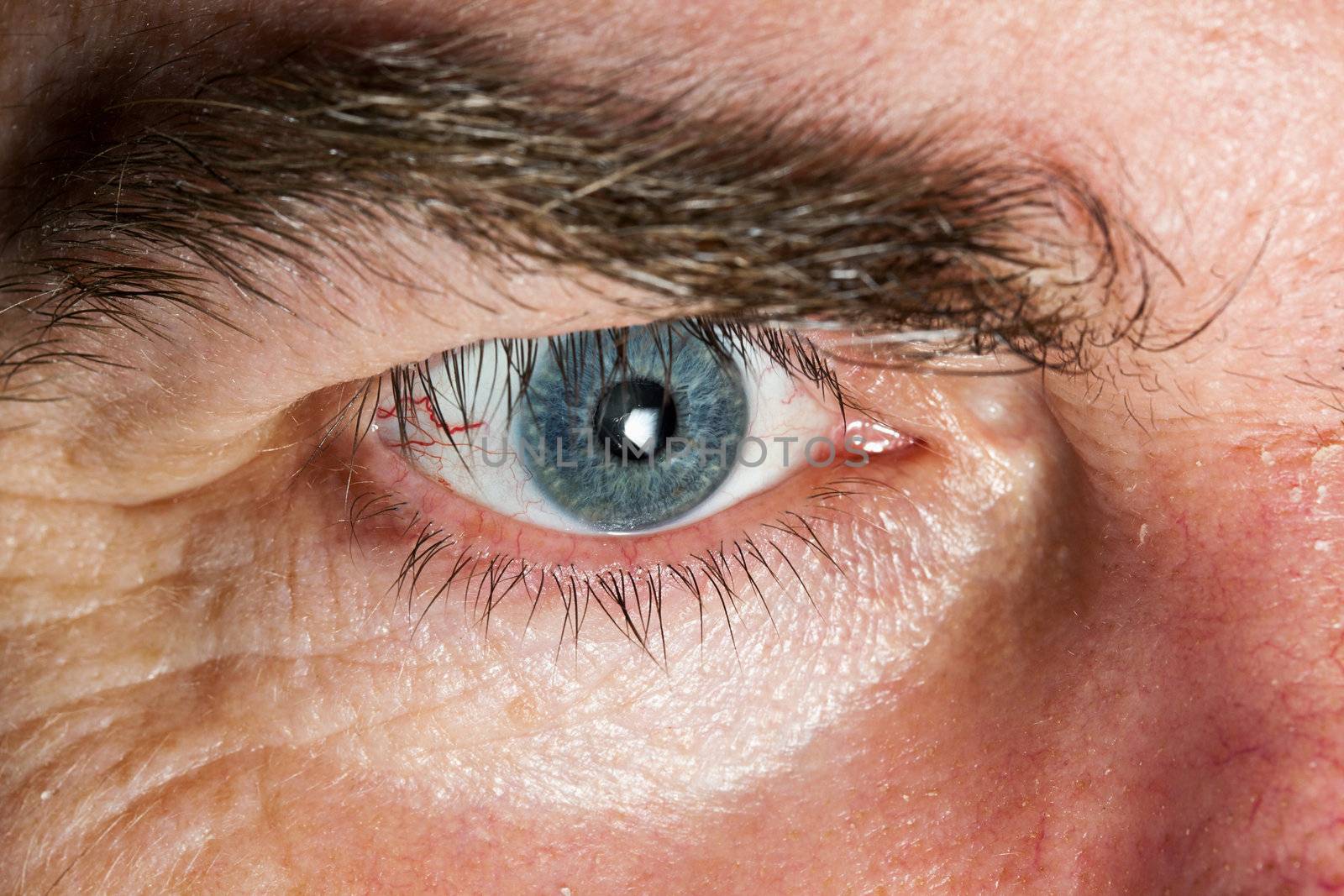 Blue Eye of mature man, close-up horizontal shot