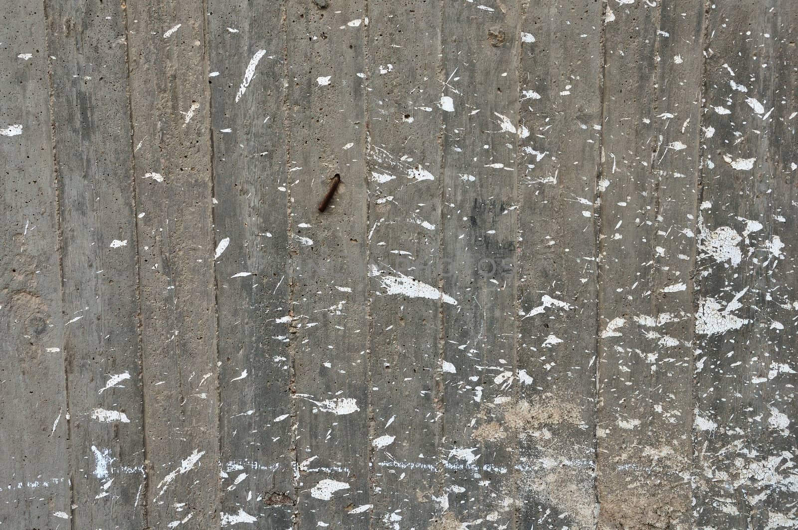 Concrete wall of under construction building. Paint stains on cement background.