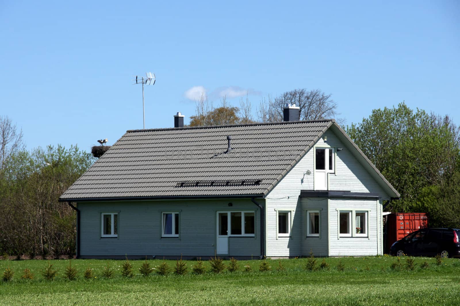 The modern house on a background of green trees