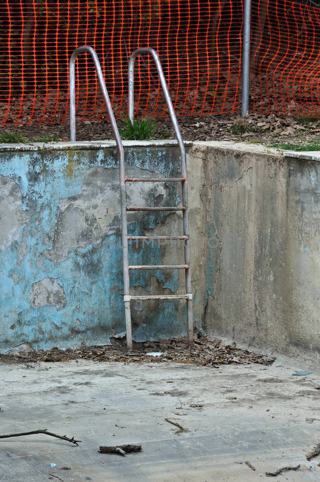 Drained swimming pool in abandoned house.