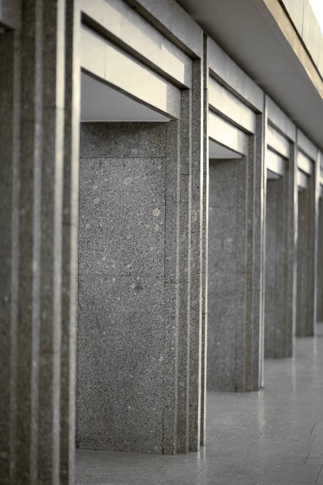 Many of columns coated with gray granite