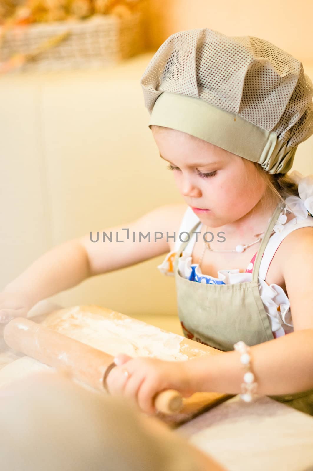 Little girl start cooking pizza and working with dough