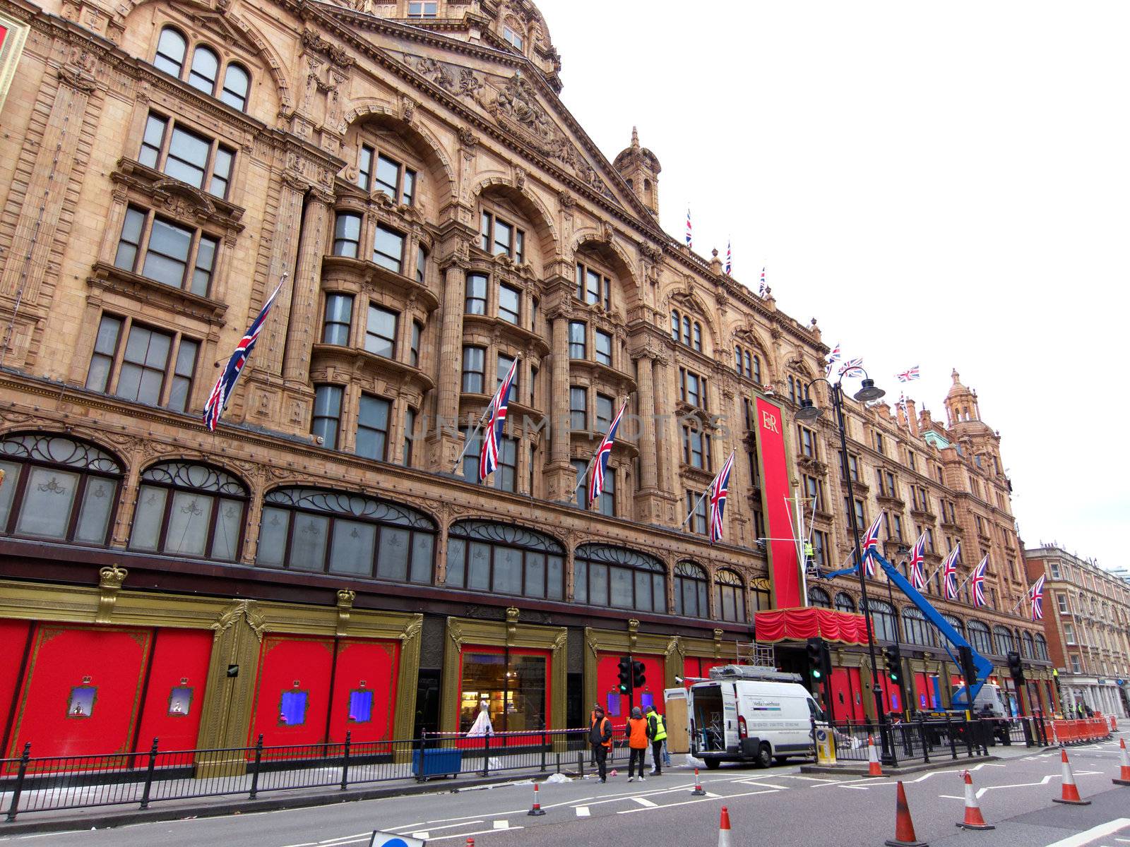 LONDON, UK - MAY 15: Workers put the last touch to the special Queen's Diamond Jubilee decoration on Harrods facade on May 15, 2012 in London.