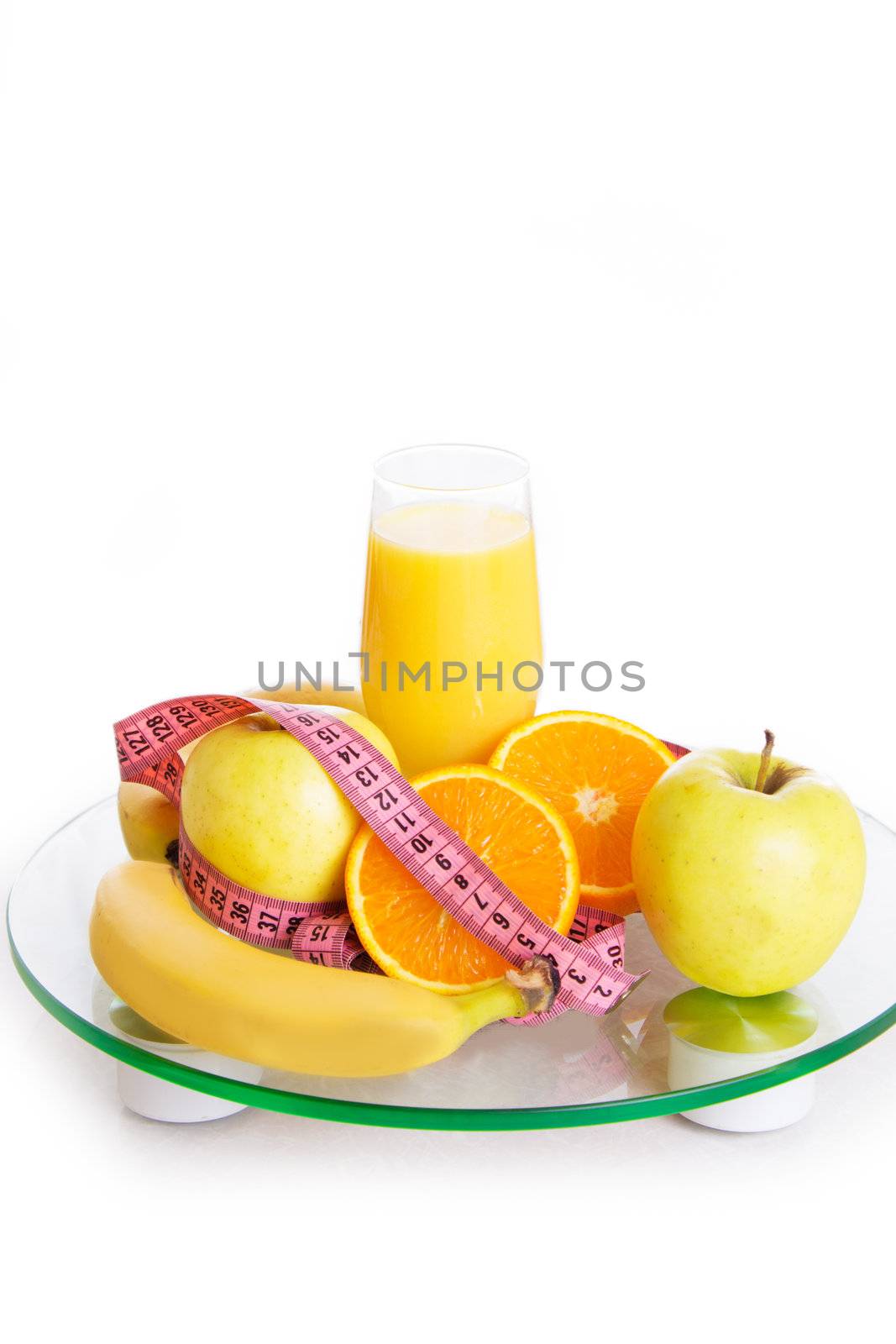 Some fruits, juice and measure tape on scales by Angel_a