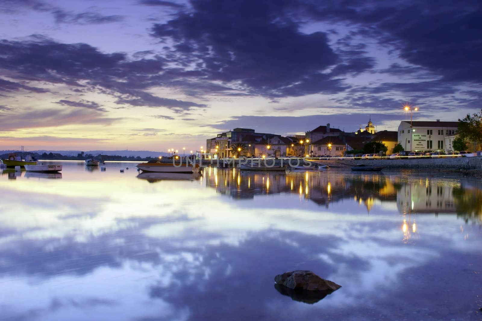 Night scenery of Seixal bay, in Portugal, with clouds