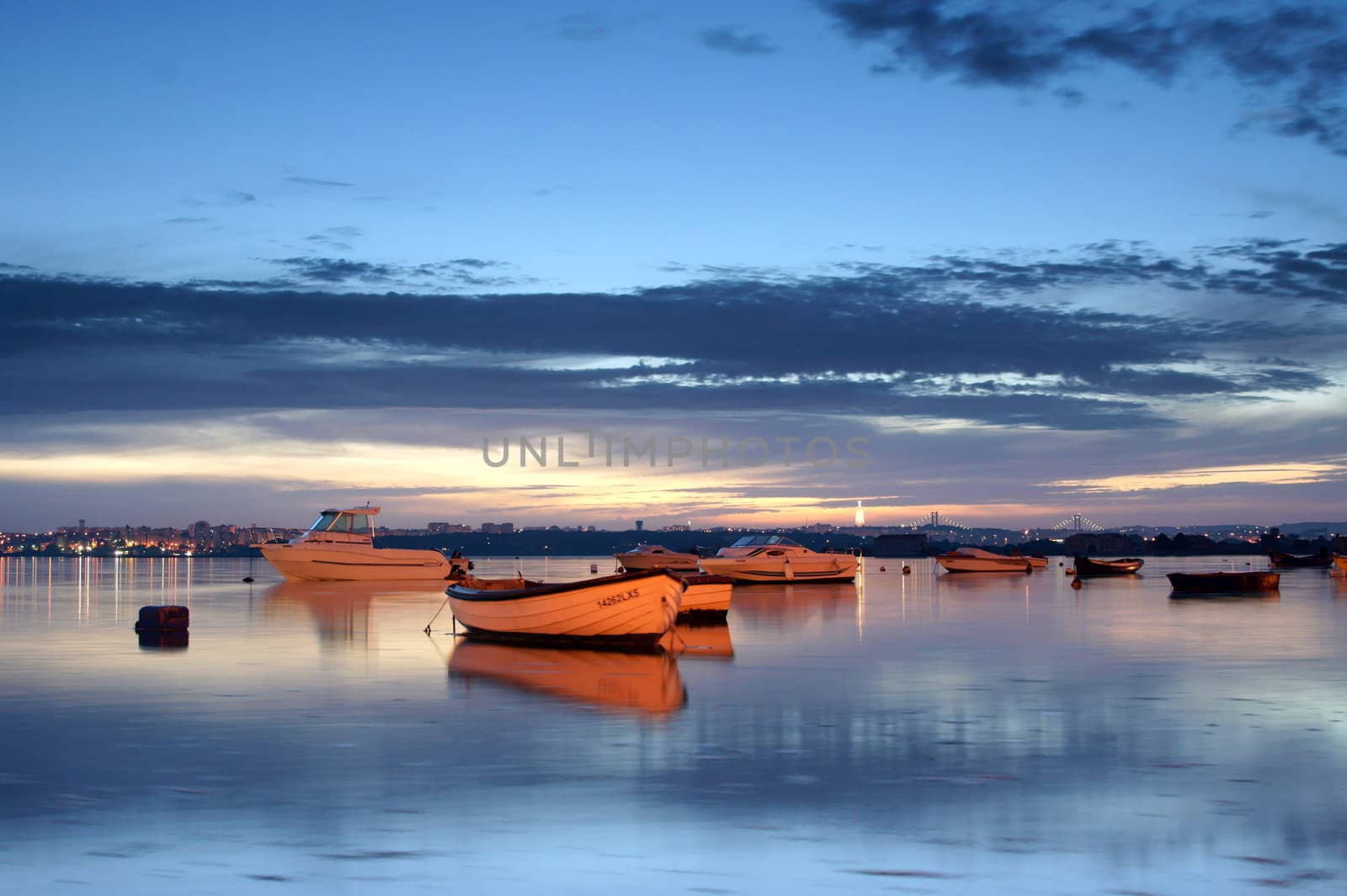 Night scenery of Seixal bay, in Portugal, with clouds