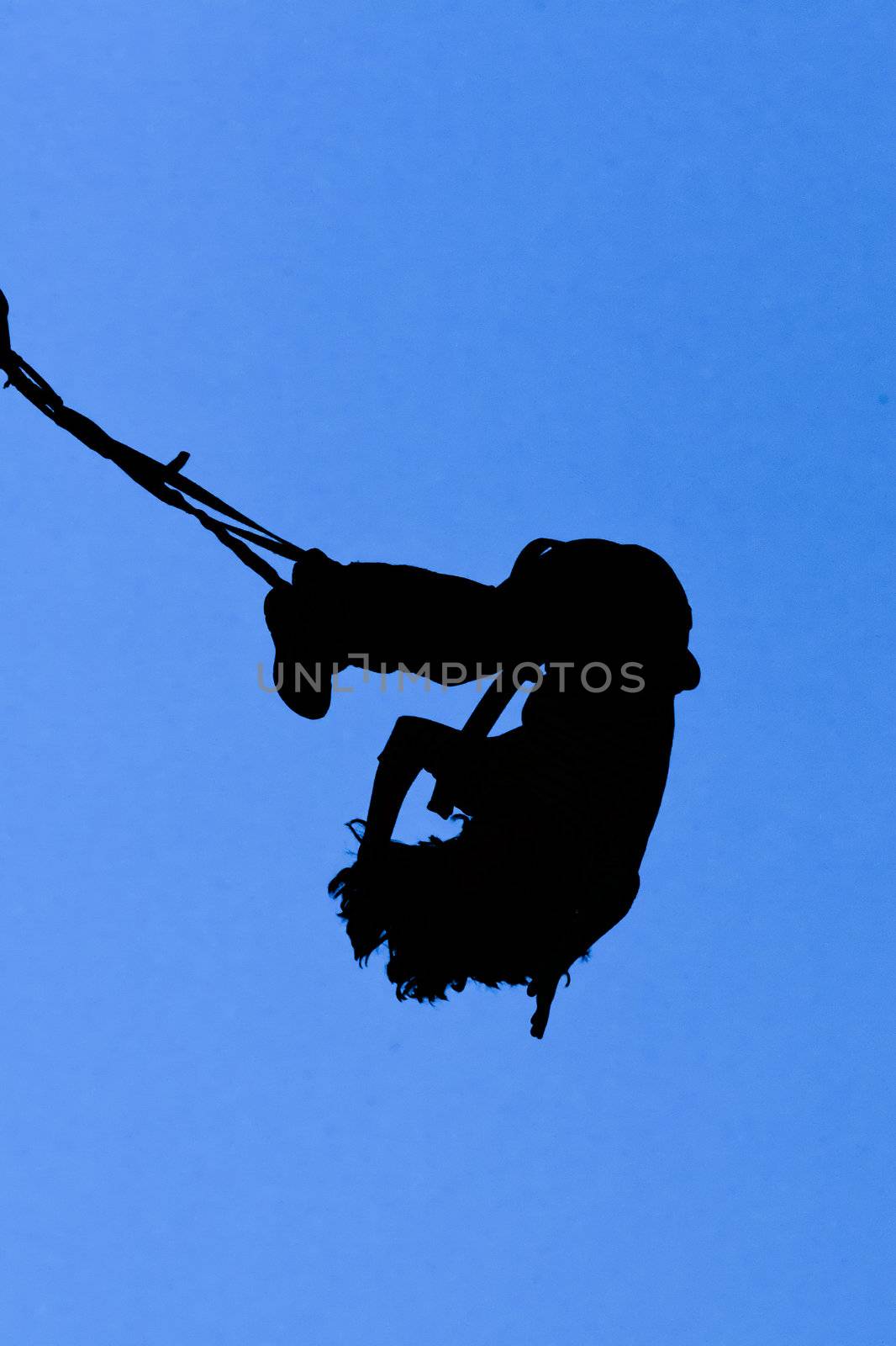 Bungee jumper against blue sky by PiLens