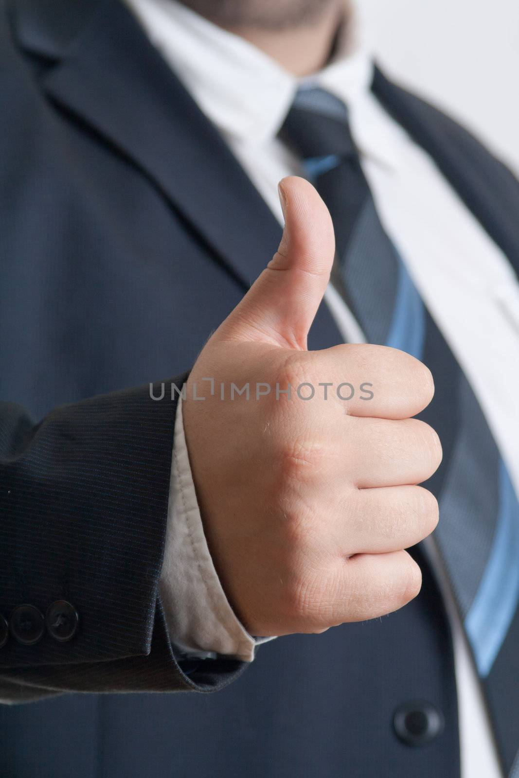 closeup of Businessman showing thumb up gesture 