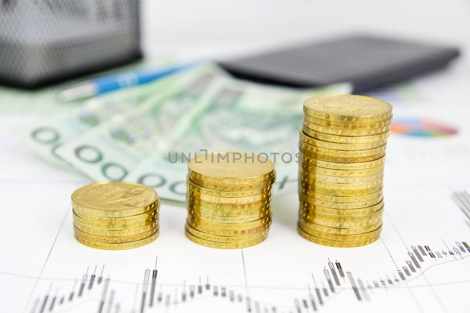 Golden coins stack. Banknotes and calculator in background