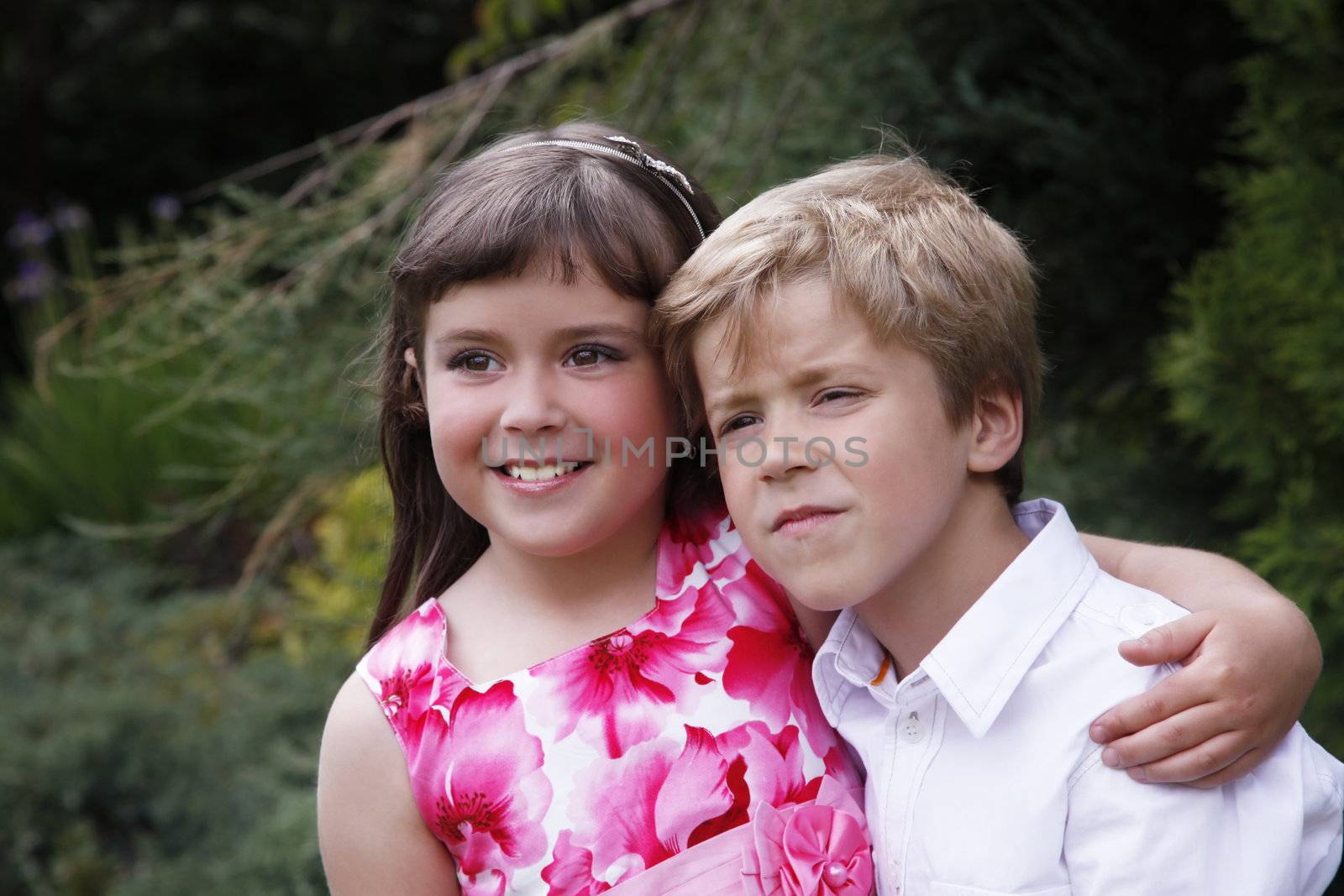 Brother and sister outdoors smiling