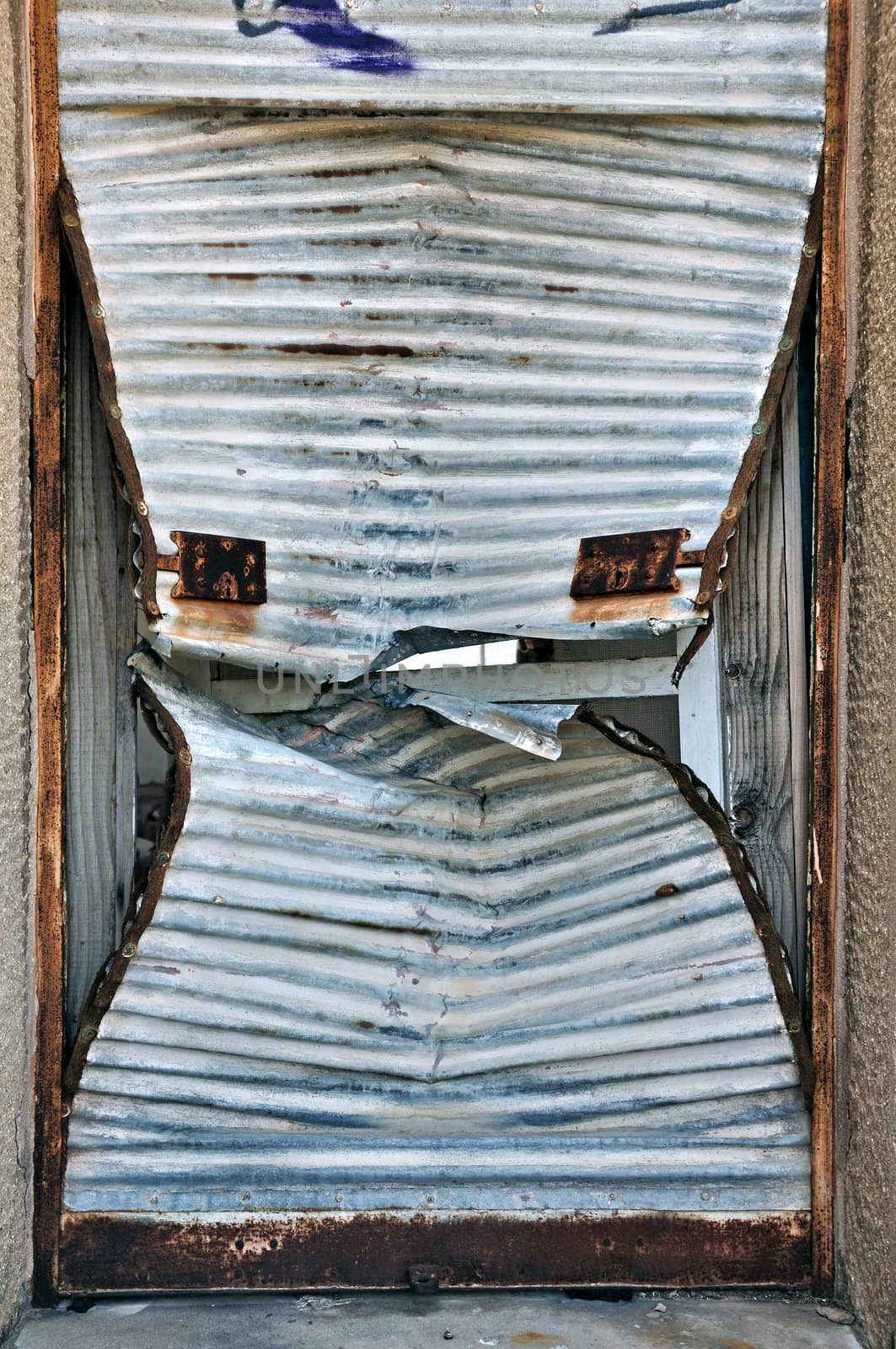 Rusty door shutter cracked open. Background metal texture.