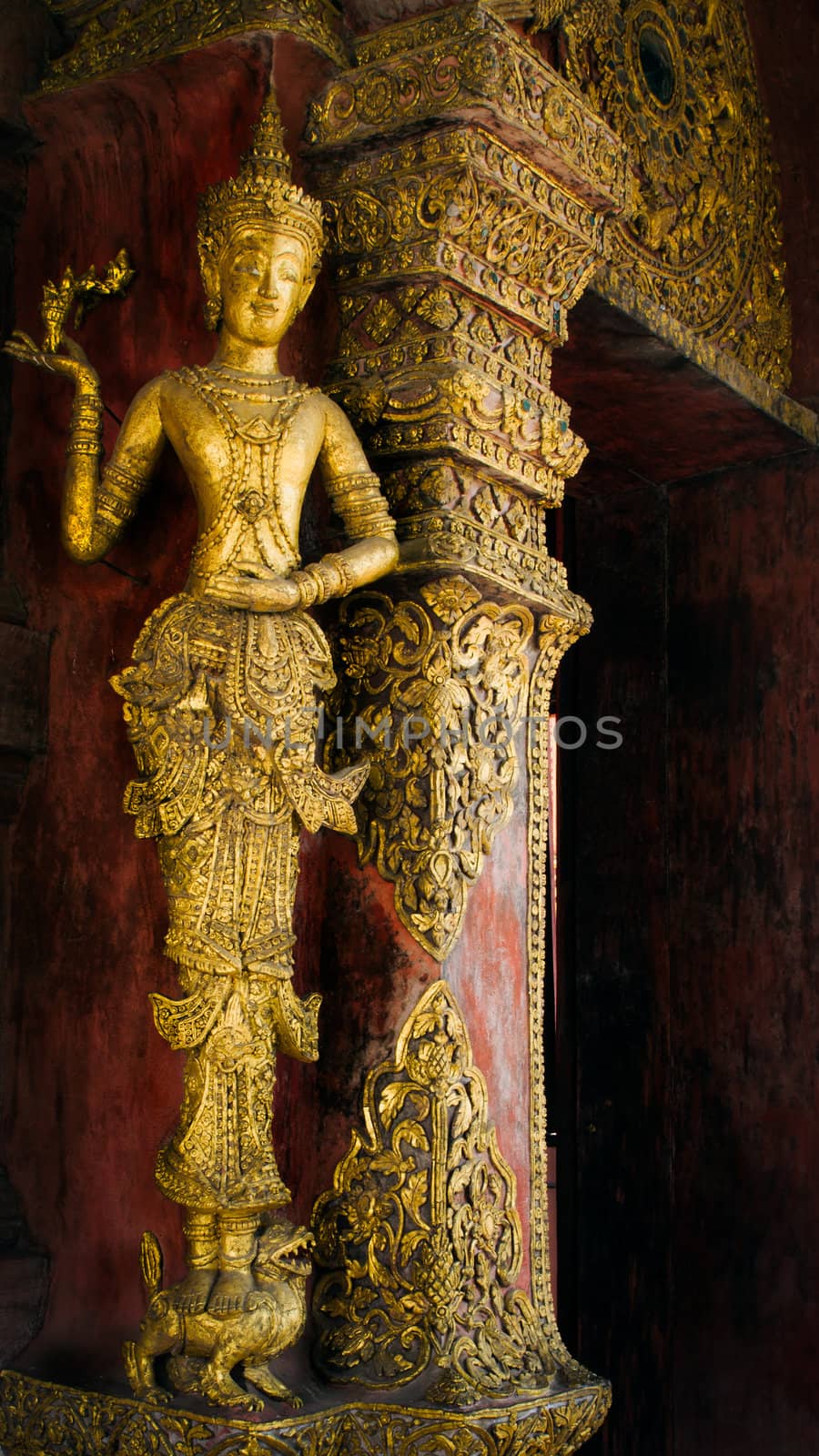 Wood carved and gilded angel at Phra Singh Temple, Chiang Mai, Northern Thailand