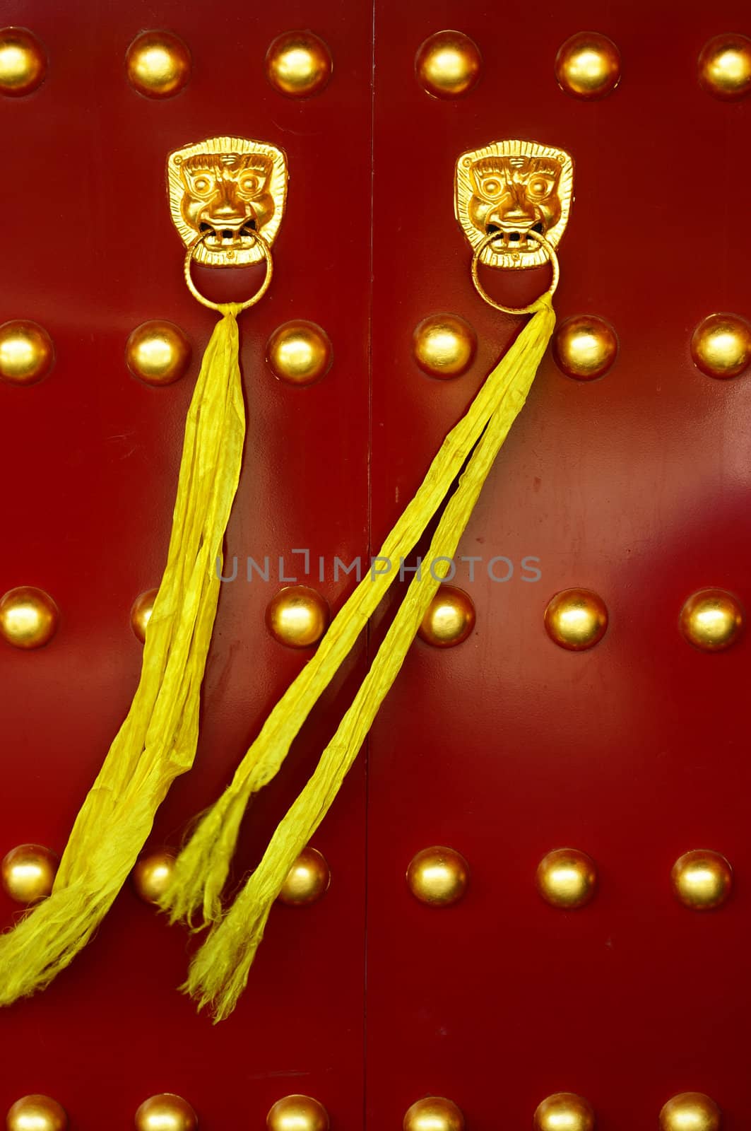 Traditional Chinese ancient red door with golden doorknobs