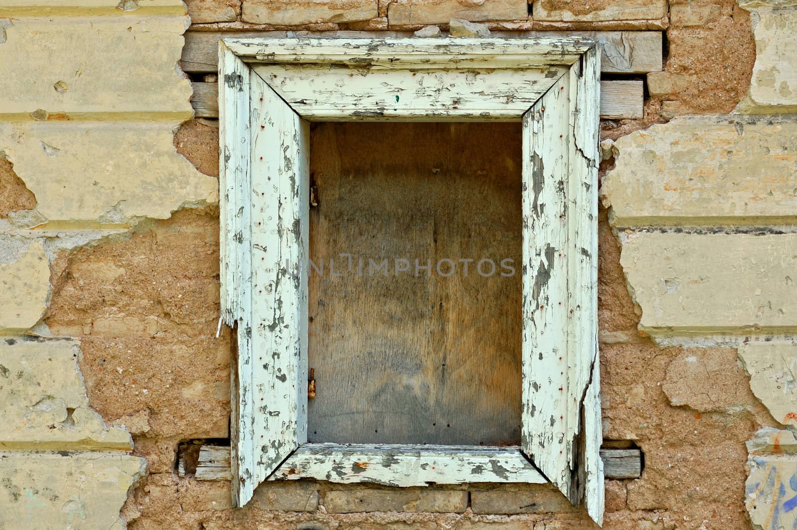 Empty wooden window frame and chipped wall texture. Grunge background.