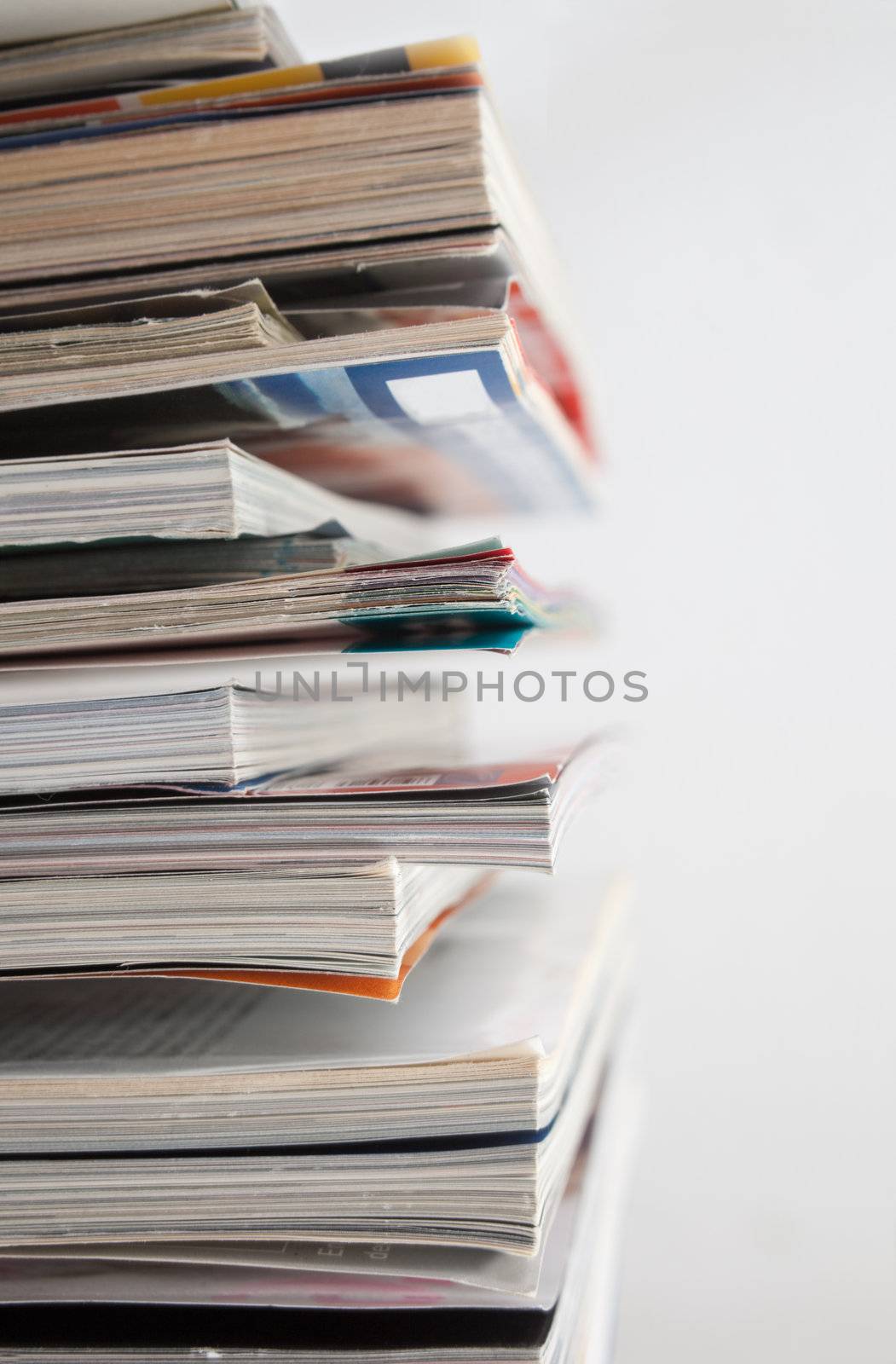 Close up image of several magazines and books
