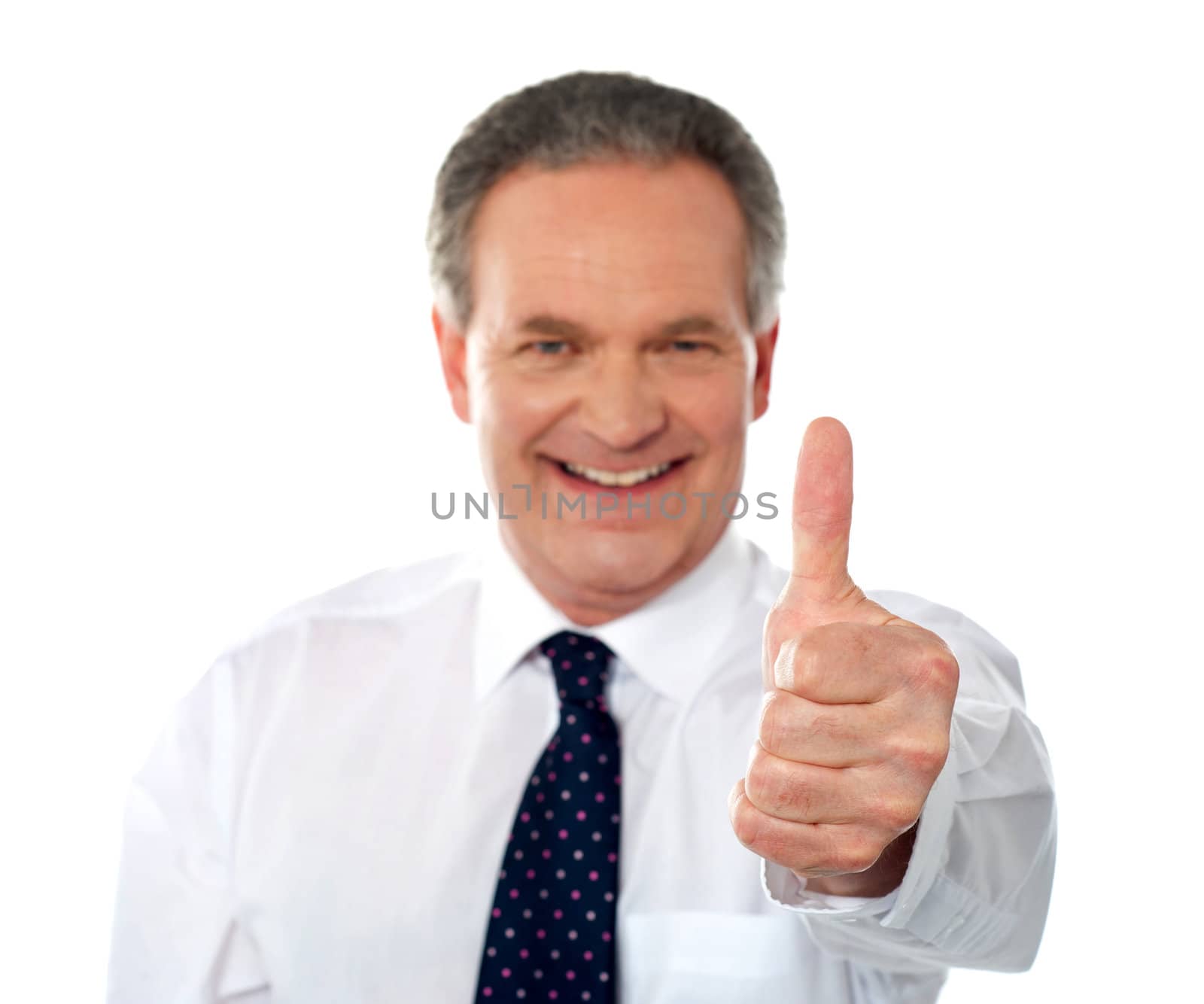 Matured businessman gesturing thumbs-up sign to you isolated on white