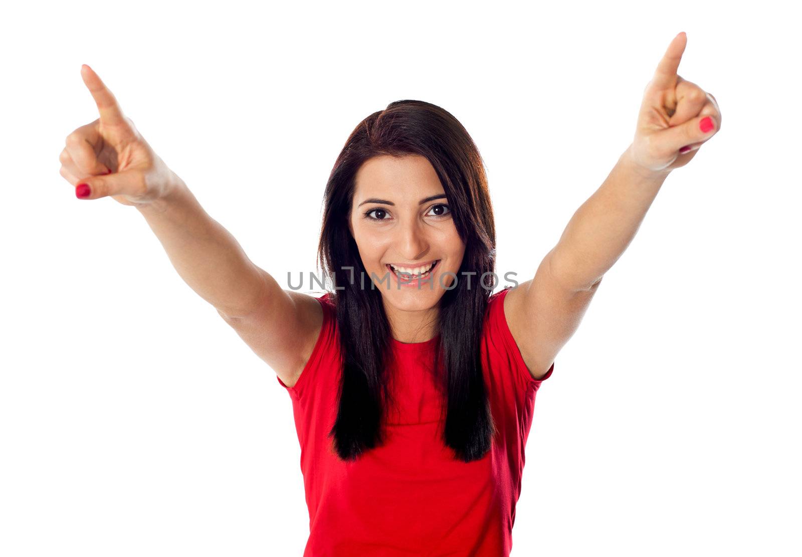 Pretty teenager excited at her success, arms raised